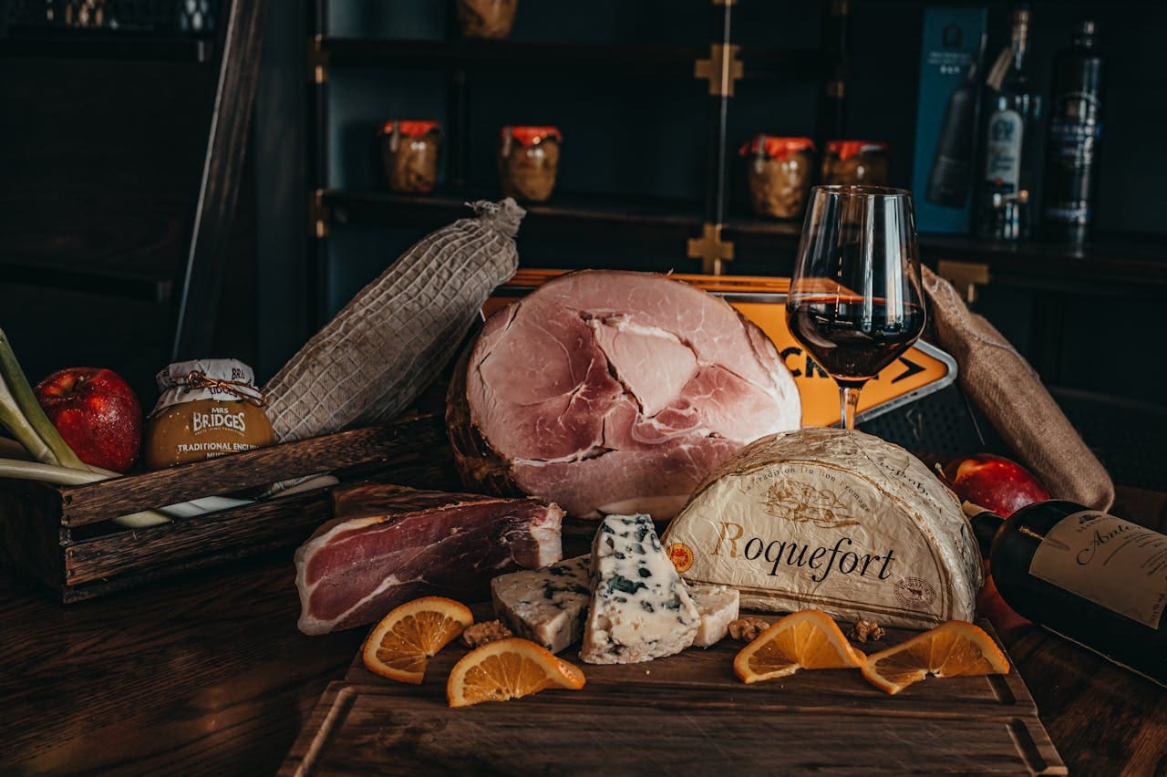 Savor a gourmet cheese and charcuterie platter with wine in an elegant indoor setting.